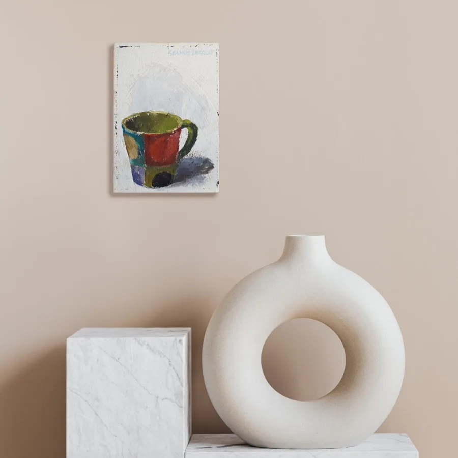 Oil painting of a colorful mug set on a light grey background displayed on a wall.