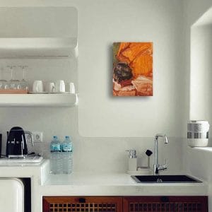 Oil painting of a black cauldron set in a background of orange and green fabric displayed on a kitchen wall.