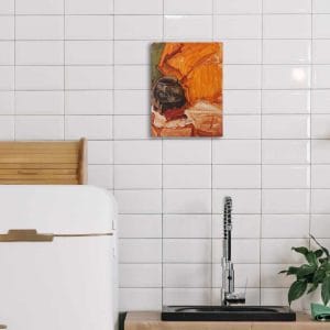 Oil painting of a black cauldron set in a background of orange and green fabric displayed on a kitchen wall.