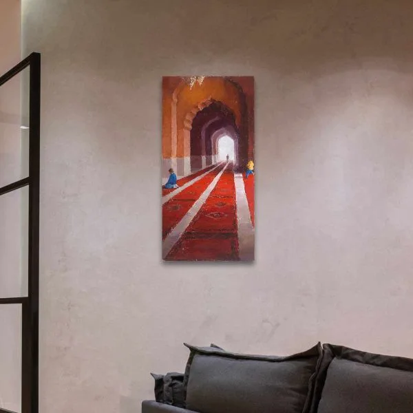 A figurative painting of people inside the Jama Masjid mosque in Old Delhi, India, showing red carpets receding into the background underneath curved archways displayed on a wall.