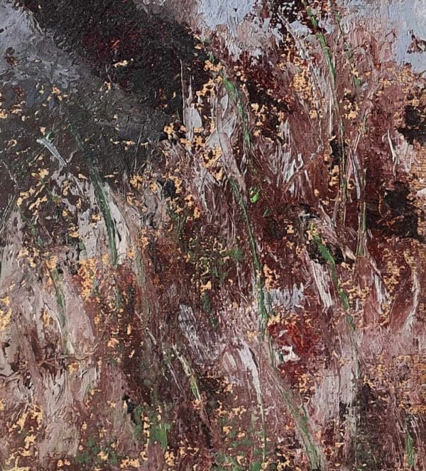 Detail of a landscape oil painting of a stone bridge over a river with autumn-colored grasses in the foreground displayed on a wall.