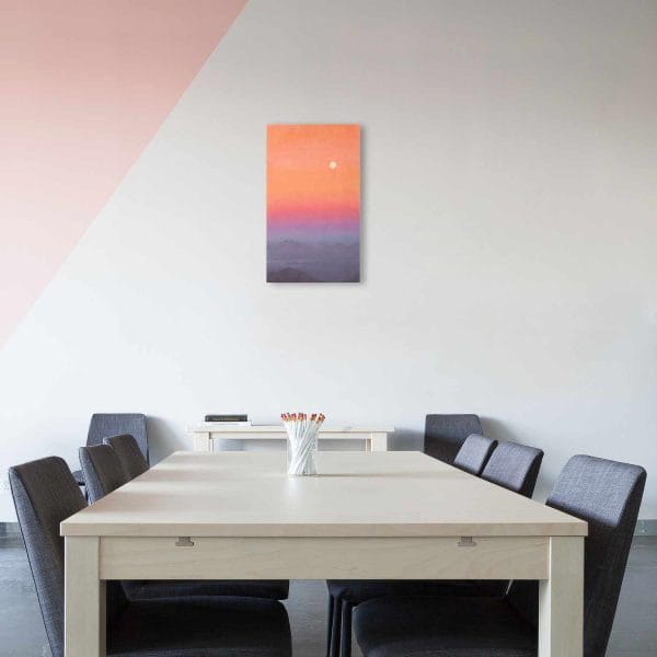 An oil painting of a full moon above the horizon and distance mountains in a vibrant, colorful sky at dusk as displayed on an interior wall.