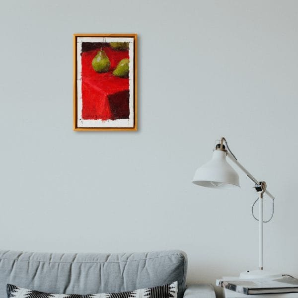 Oil painting of three green pears arranged on a bright red table cloth on a wall setting.