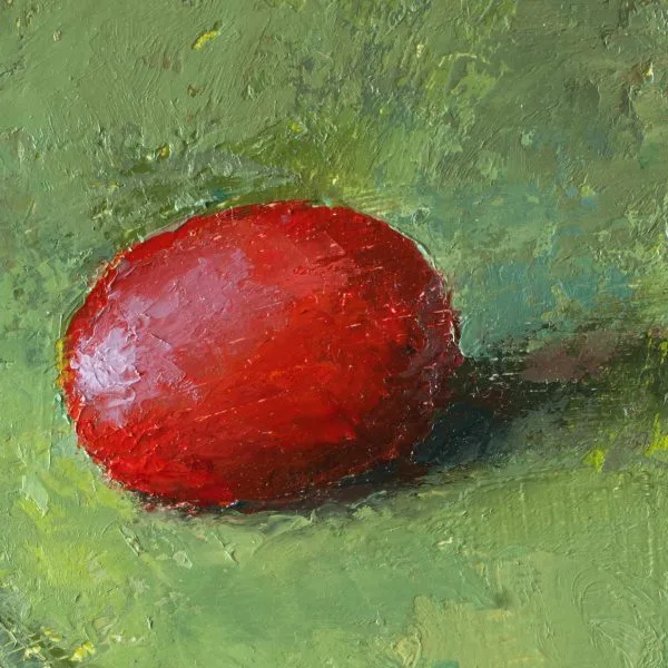 Detail of an oil painting of a green grape on red fabric juxtaposed with a red grape on a green fabric.