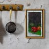 An oil painting of a red, orange and green peppers on a contrasting background of bright green and dark violet invite you to see colorful vegetables a new way as displayed on an interior wall.