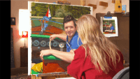 Artist in front of canvas on an easel, with paint and brushes used in creating a portrait painting of a young man on boat.