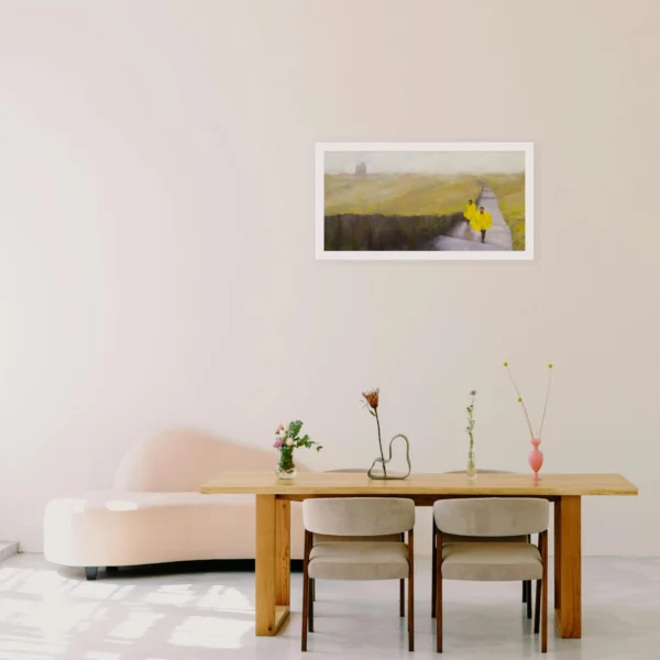 Image of an oil painting of two figures in bright yellow rain coats walking in the rain and mist at the Cliffs of Moher in Ireland with the soft silhouette of a castle ruin in the background displayed on a wall in a home setting.