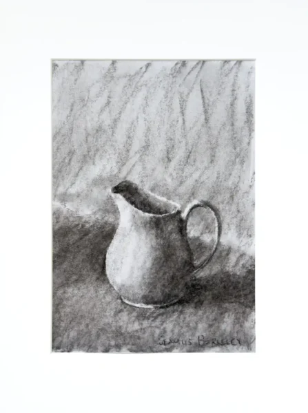 A charcoal drawing of a white pitcher with a handle on the right placed on a grey fabric.